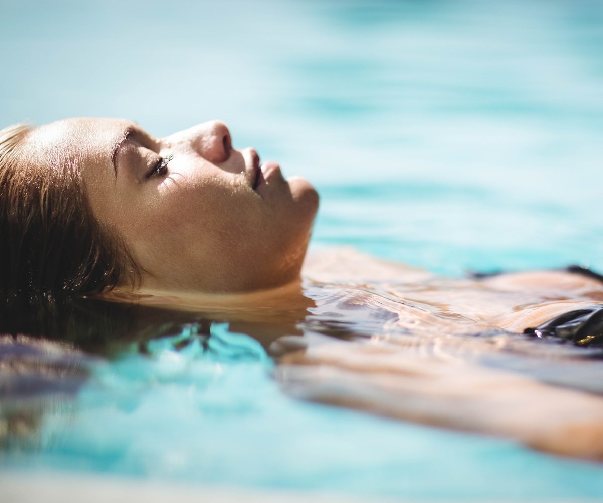 woman-floating-relaxation-pool-water-serenity
